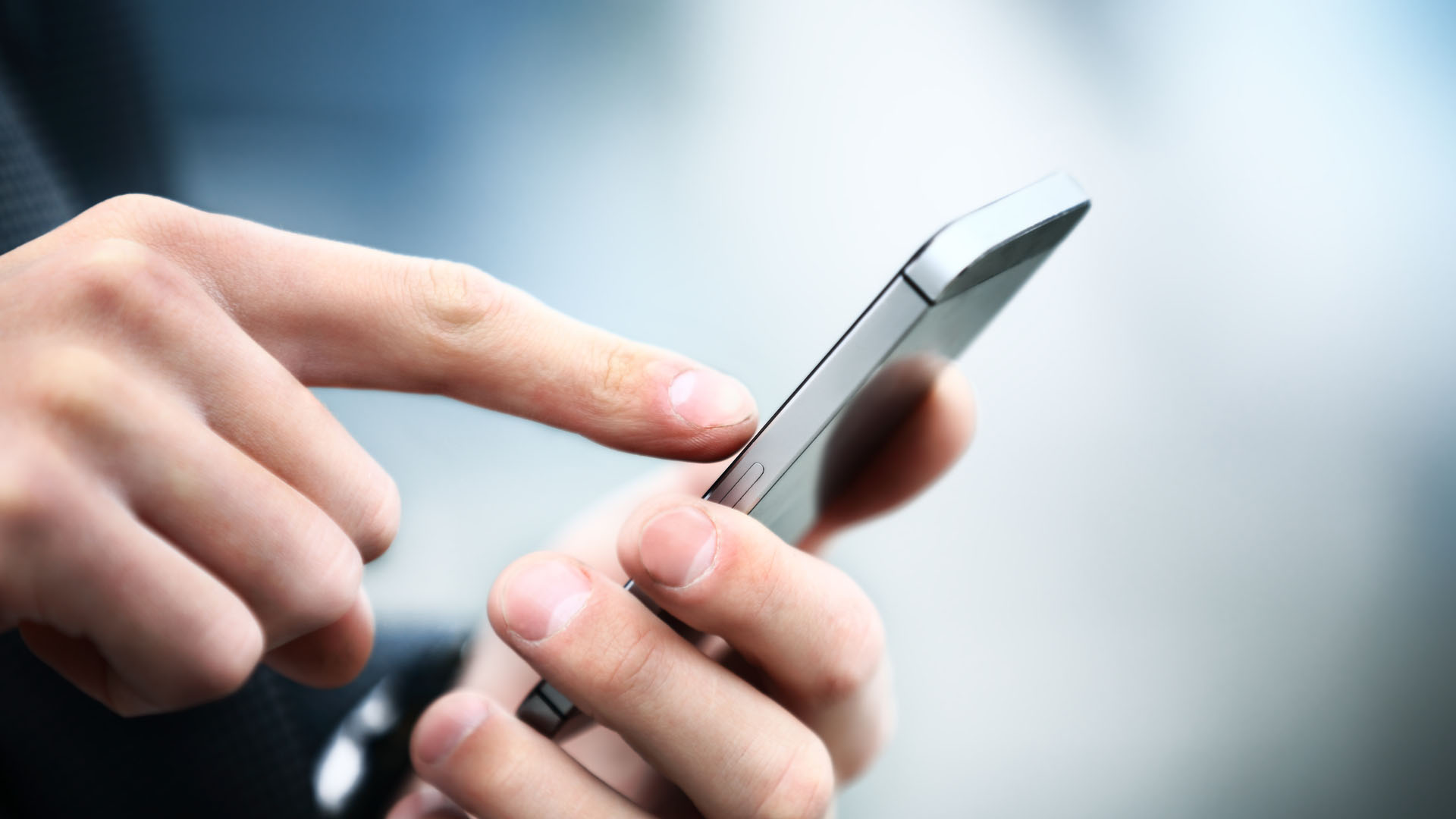 Male hand touching mobile phone