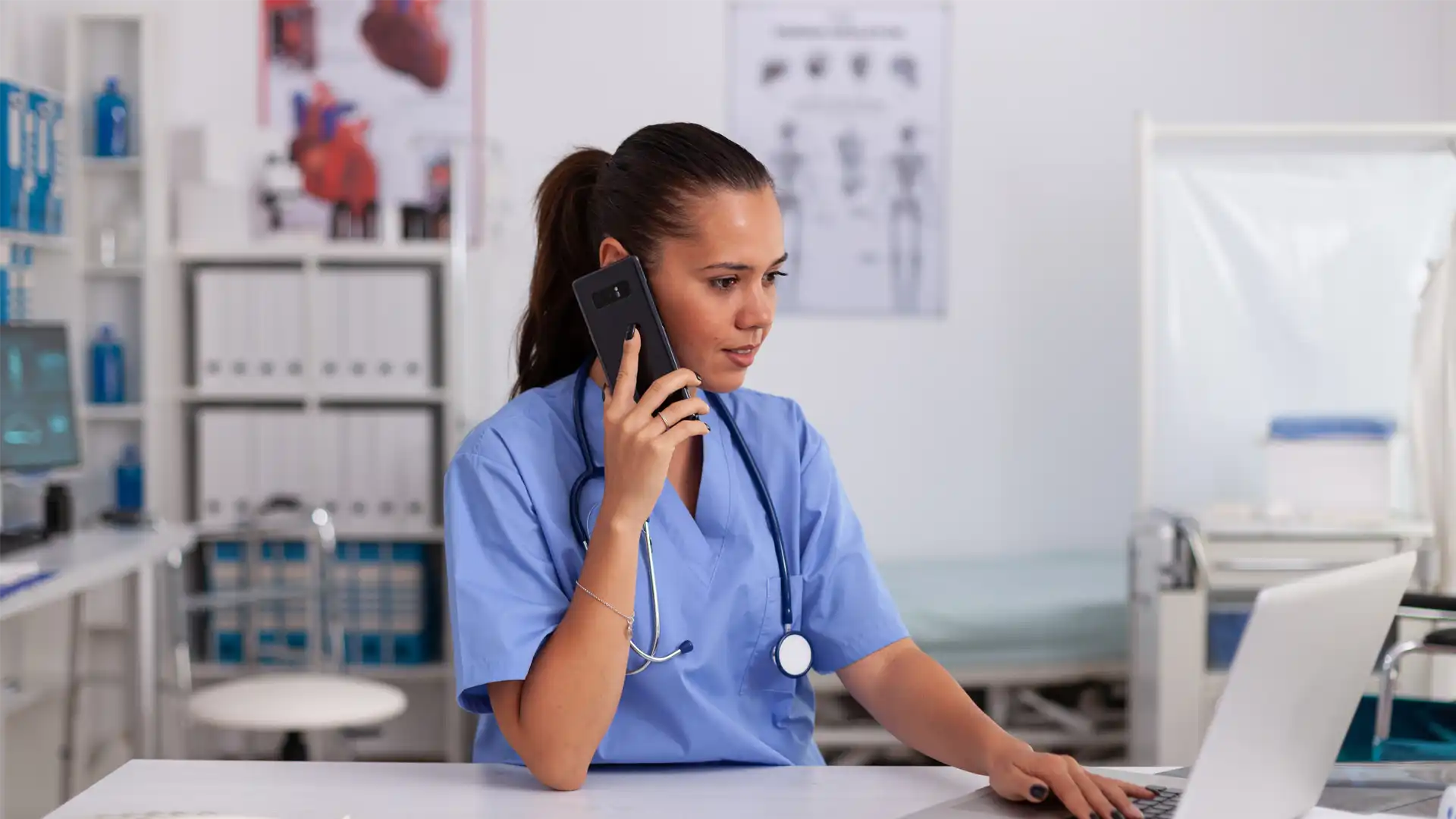 Nurse on phone at hospital desk