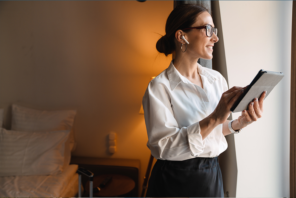 Woman On Ipad And Headphones In Hotel