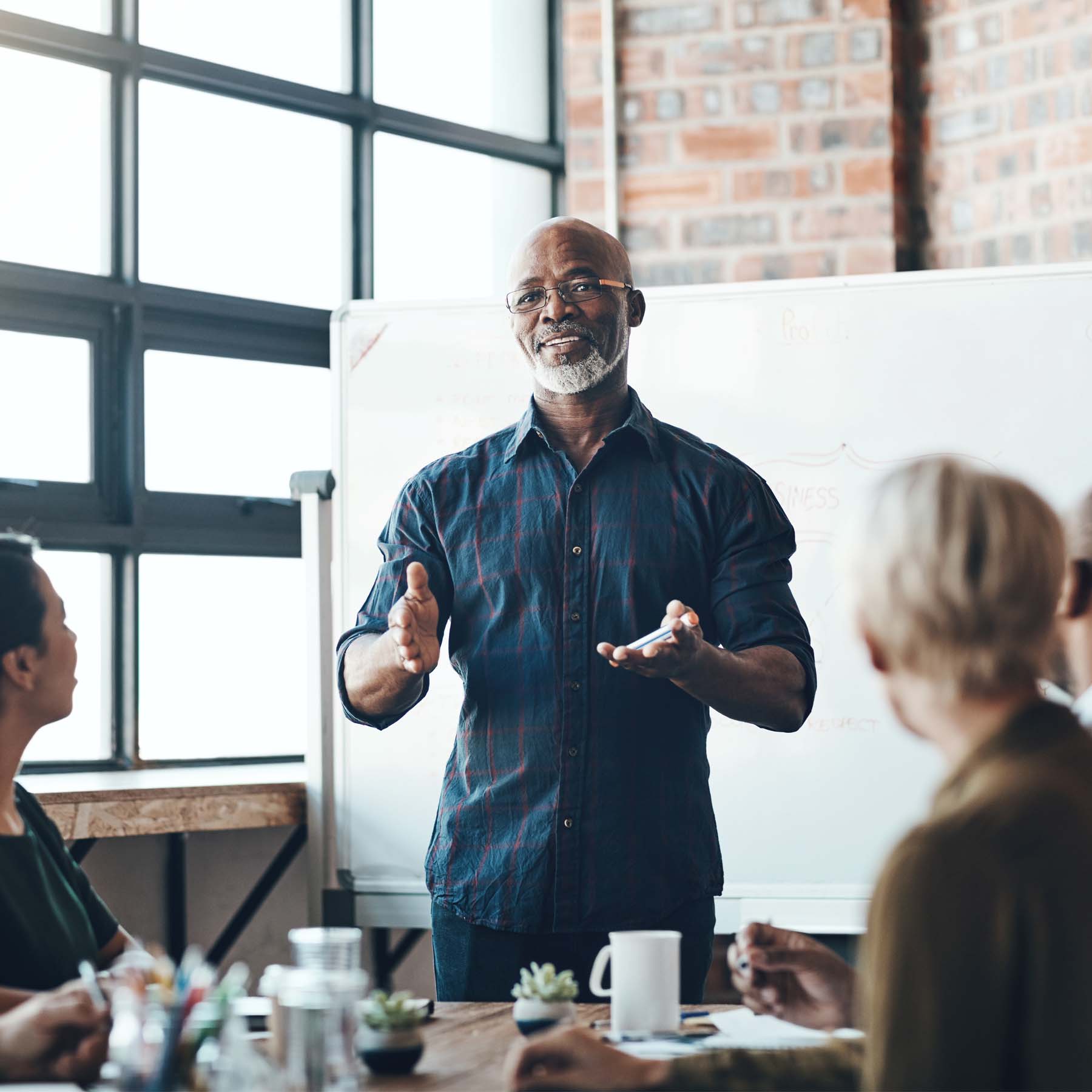 Business Leader talking to Colleagues in Meeting