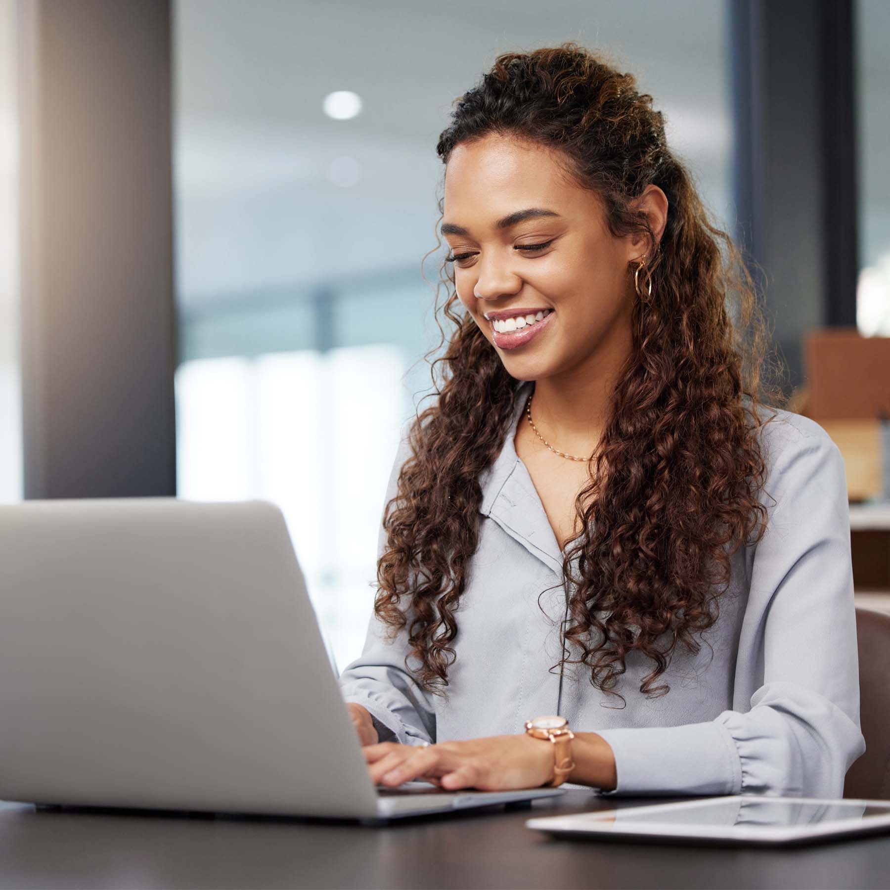 Woman smiling working on laptop