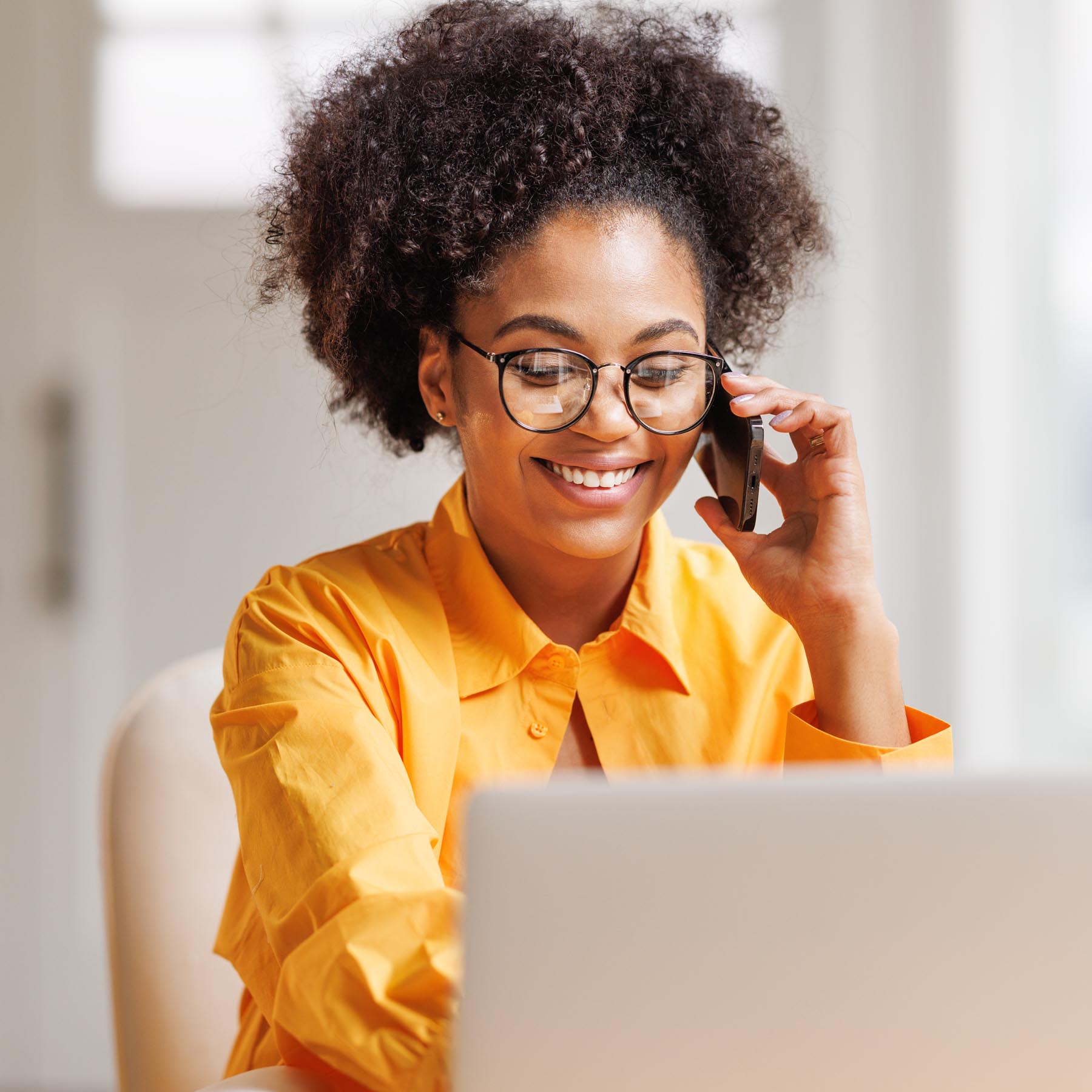 Female Worker on Laptop and Mobile Phone
