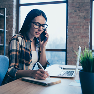 Woman on laptop and phone