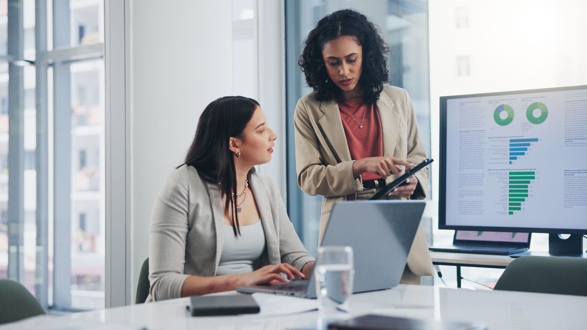 Female Colleagues discussing analytics and findings